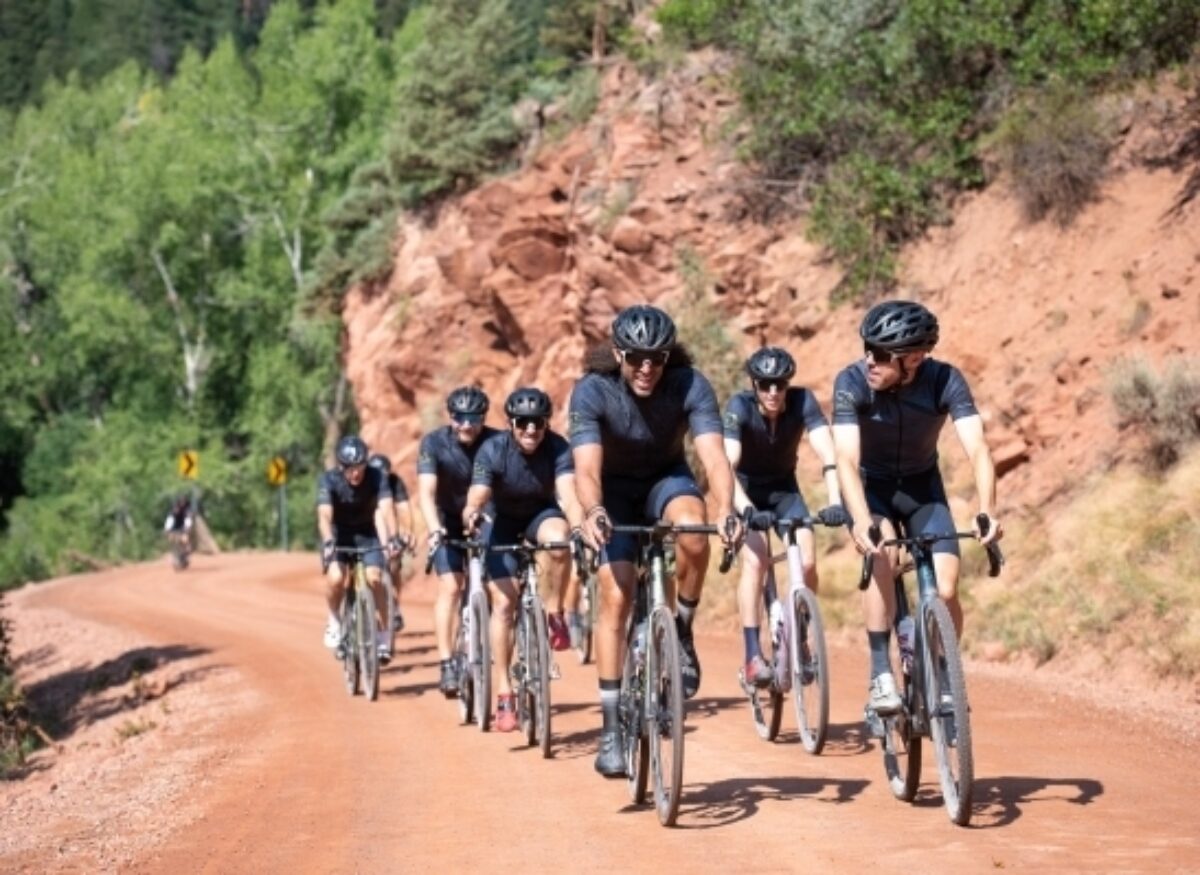 Group of gravel bikers riding up a hill