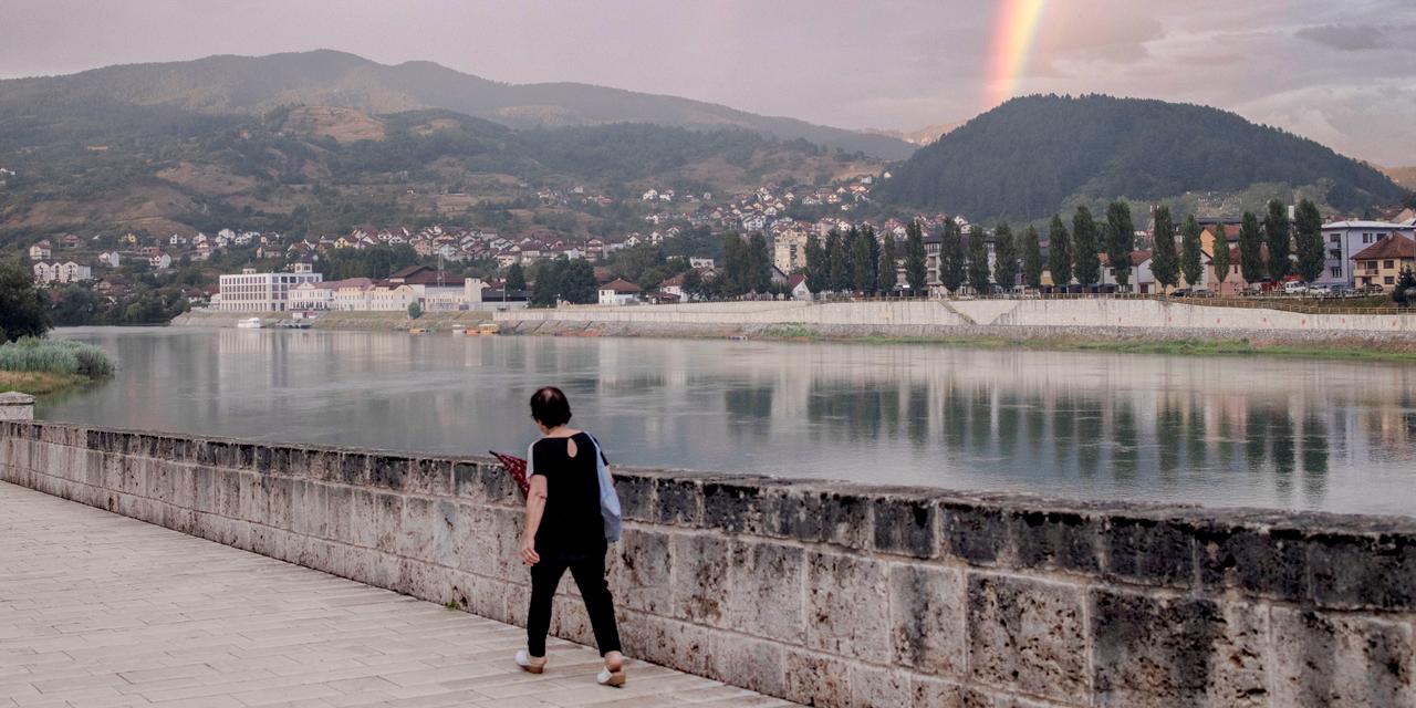 Une passante marche le long de la rivière Drina, à Vicegrad en Bosnie-Herzégovine, le 8 juillet 2025.