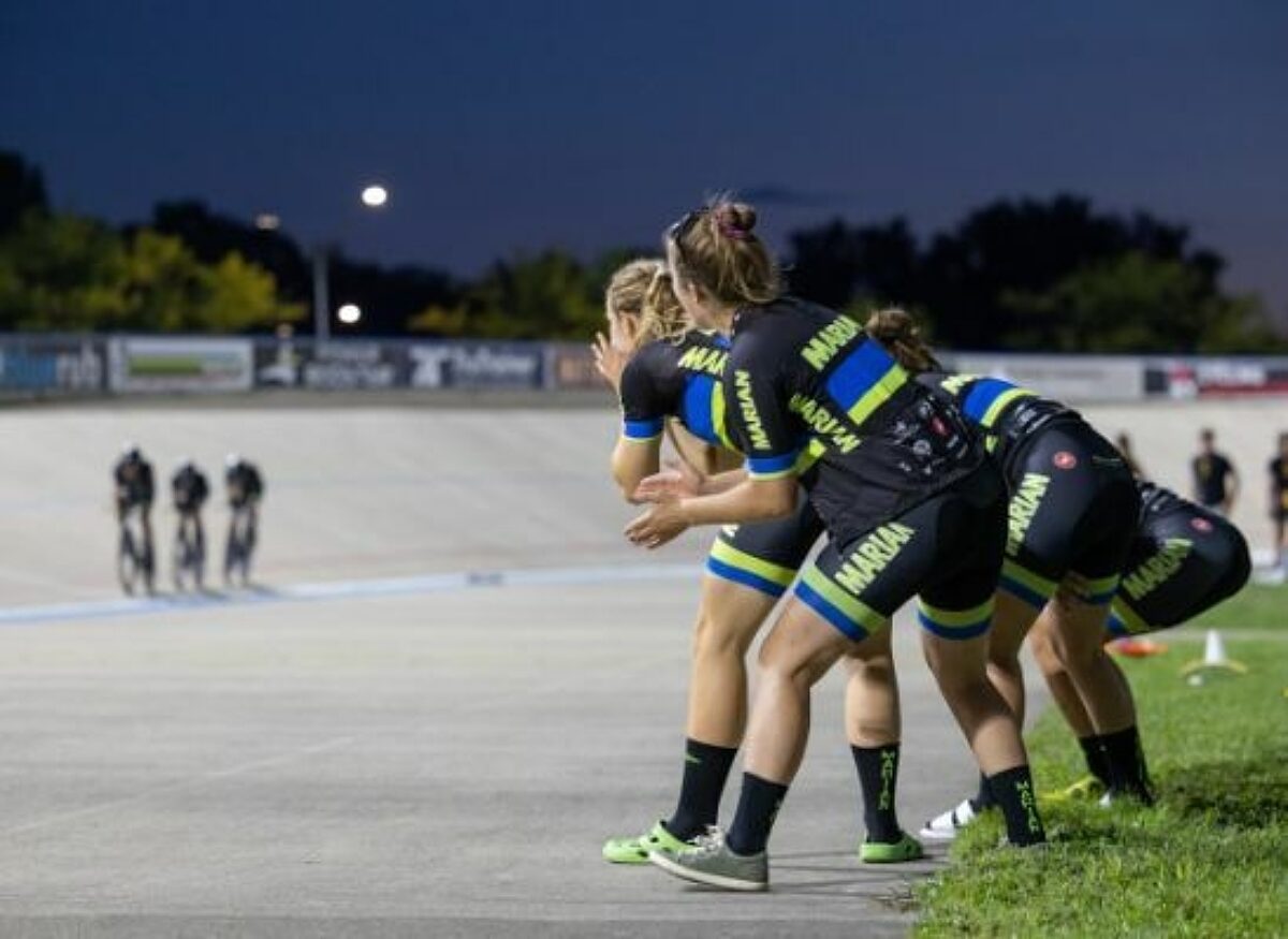Women in bike clothing cheering on competing bikers