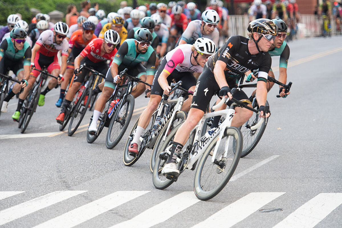 Road race with cyclists going through a corner.